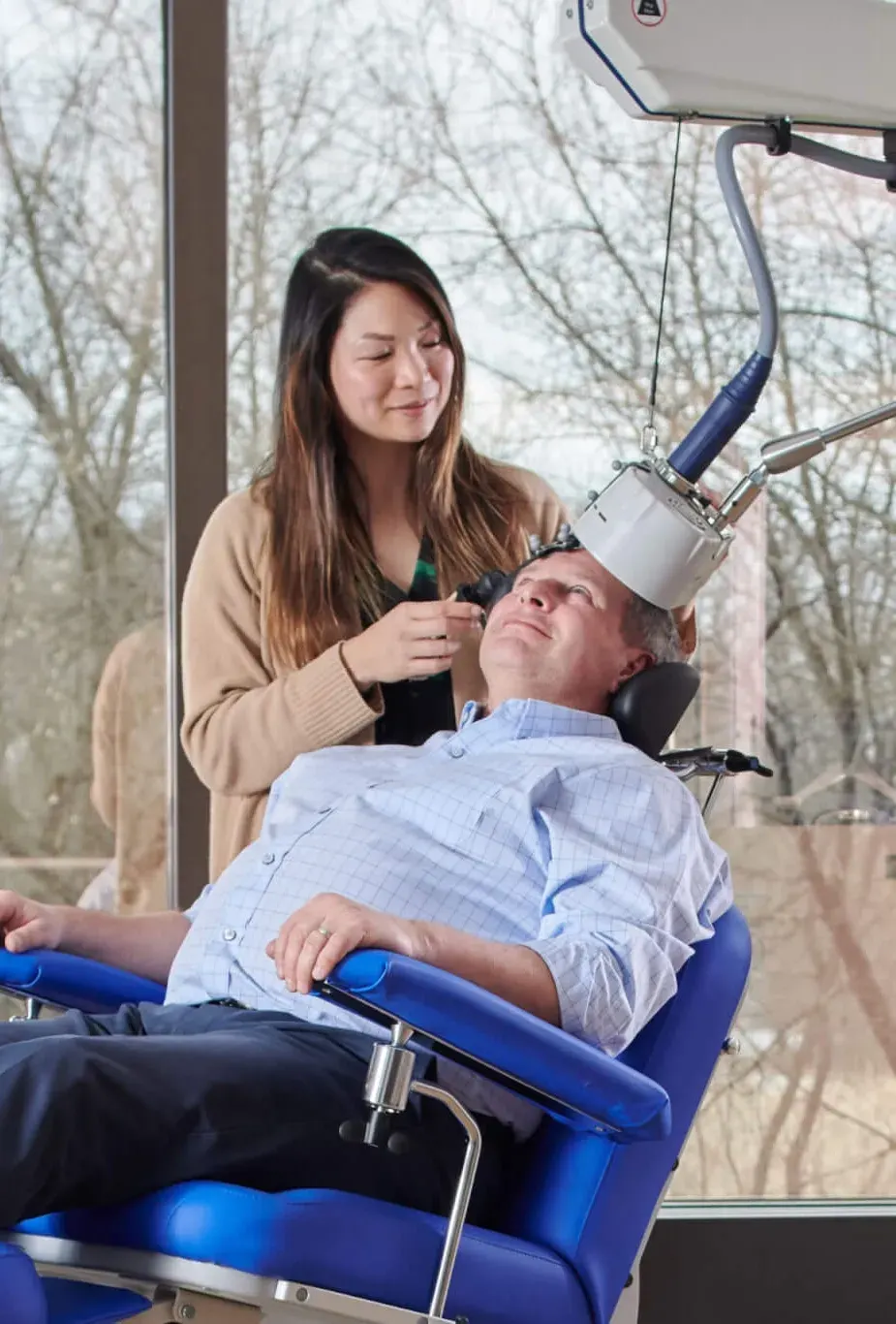 Clinician reviewing a TMS safety screening checklist with a patient at R&C Psychiatry in Miami, Florida